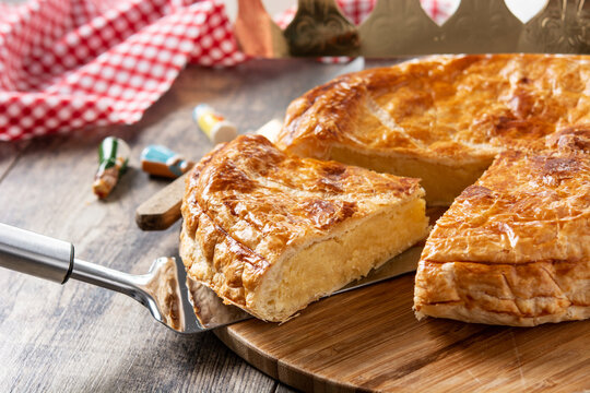 Galette des rois on wooden table. Traditional Epiphany cake in France	