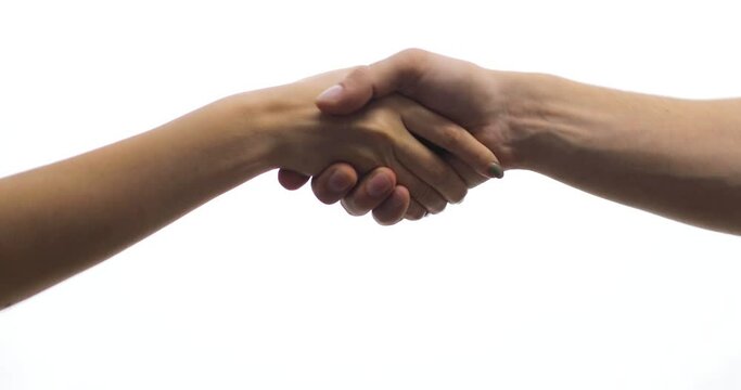 Close-up of handshake of man and woman on white background, isolated. Woman's and man's hands greeting. Gestures, symbols and signs.