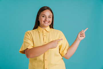 Young white woman wearing shirt laughing and pointing fingers aside