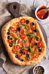 Freshly baked pizza on a wooden board