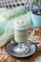 Still life with matcha tea latte in glass on light background
