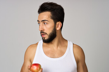 Cheerful man apples in hands fruit healthy food light background