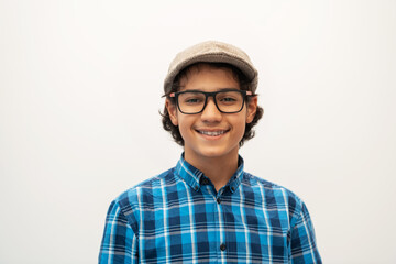 portrait of smart looking arab teenager with glasses wearing a hat in casual school look isolated...