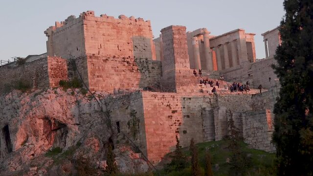 Tourists at the Parthenon's during sunset in Athens, Greece.
