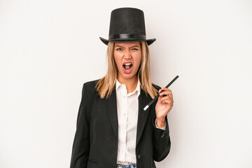 Young caucasian wizard woman holding wand isolated on white background screaming very angry and aggressive.