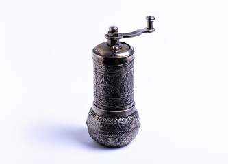 isolate, manual metal pepper grinder on white background, close-up