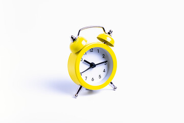 isolate, yellow alarm clock on white background, close-up