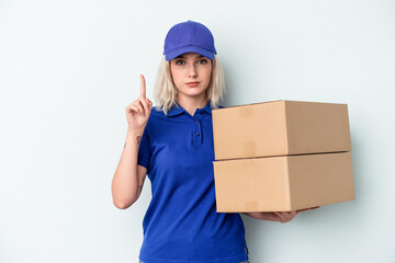 Young delivery caucasian woman isolated on blue background showing number one with finger.