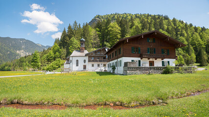 chapel and farmstead, tourist destination bath house Wildbad kreuth in spring, creek with healing water