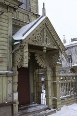 Porch door of wooden house with ornamental windows, carved frames of merchant Sapozhnikov on...