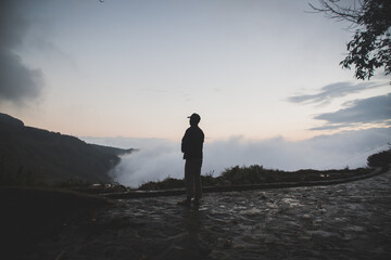 silhouette of a man walking on the mountain on sunrise 
