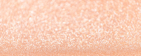 Abstract blurred coral or peach magic glitter banner with copy space.