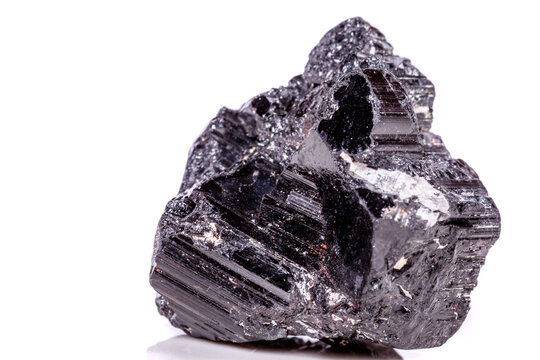 macro mineral stone sherle, schorl, black tourmaline on white background