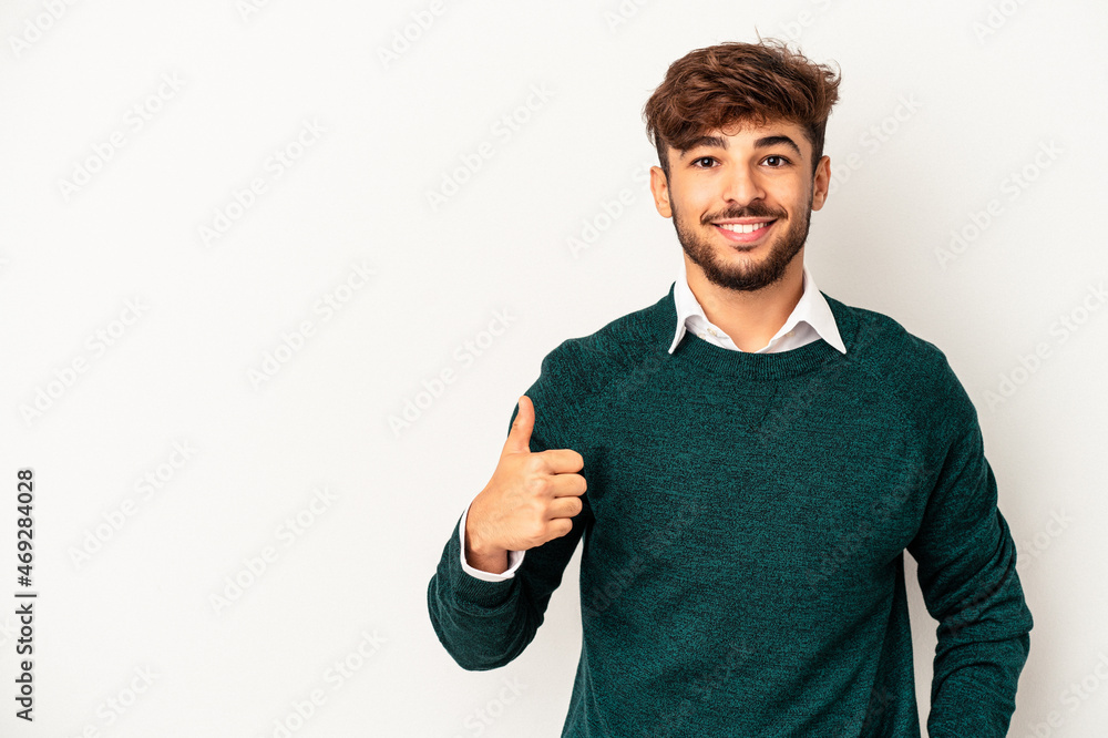 Wall mural Young mixed race man isolated on grey background smiling and raising thumb up