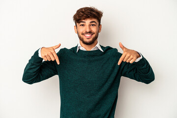 Young mixed race man isolated on grey background points down with fingers, positive feeling.