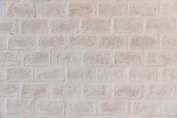 White brick wall background in rural room. Abstract weathered texture stained old stucco light gray. White grunge brick wall background. Misty brick wall for background or texture.