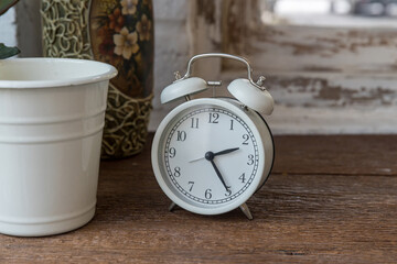 Focus alarm clock vintage style with blurry white background in the bedroom. wake up maker, wake up morning tool. 
