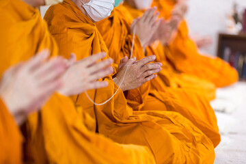 Pray of monks on ceremony of buddhist in Thailand. Many Buddha monk sit on the red carpet prepare...