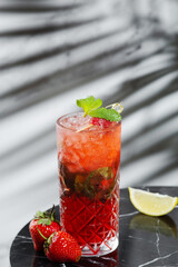 strawberry mojito with ingredients near on marble table. Fresh cocktail or lemonade. bar concept. hard shadow on background