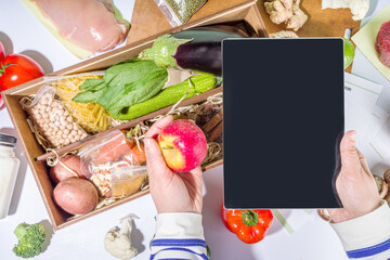Meal Kit Delivery Concept. Set various healthy dishes food ingredients meat, vegetables, fruit, spices with recipes for cooking. Online ordering of restaurant chef foods ingredients, grocery delivery,