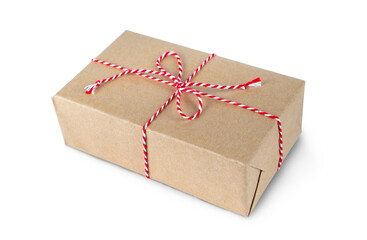 Christmas and New Year gift box wrapped in craft paper with red ribbon bow isolated on white background