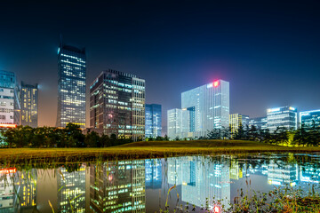 Fototapeta na wymiar Night view of office buildings in Suzhou Financial District, China