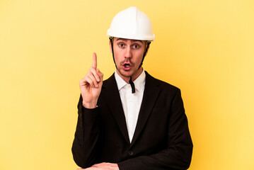 Young architect caucasian man isolated on yellow background having some great idea, concept of creativity.
