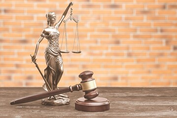 Themis statue and wooden gavel, symbols of law and justice. Law concept.