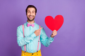 Photo of cool young brunet guy index heart wear tie suspenders blue shirt isolated on purple background