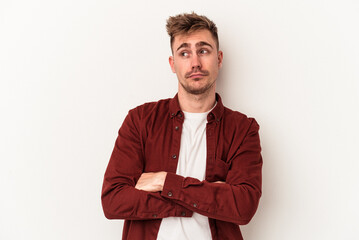 Young caucasian man isolated on white background dreaming of achieving goals and purposes