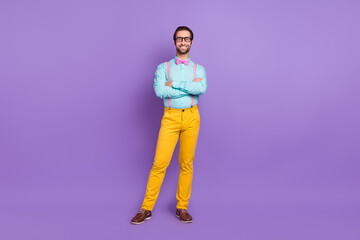 Fototapeta na wymiar Full size photo of nice millennial hipster brunet man crossed arms wear tie suspenders shirt spectacles trousers sneakers isolated on violet background