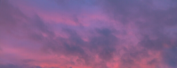 Pink purple twilight sky with dark light clouds