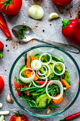 cooking vegetables on the stone background top view