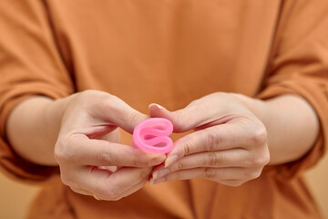 Close-up of young woman hands folding a menstrual cup.
Women health concept, zero waste alternatives