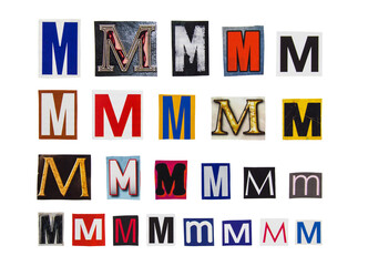 Alphabet letter M cutting from magazine paper. Newspaper clippings with letter M isolated on white background. Anonymous text concept.