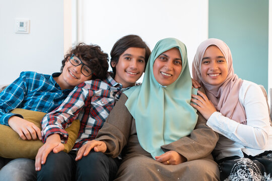 Middle eastern family portrait single mother with teenage kids at home in living room. Selective focus 
