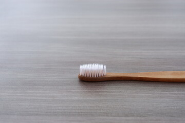 Fototapeta na wymiar Close-up photo of a toothbrush against a wood texture background from various angles