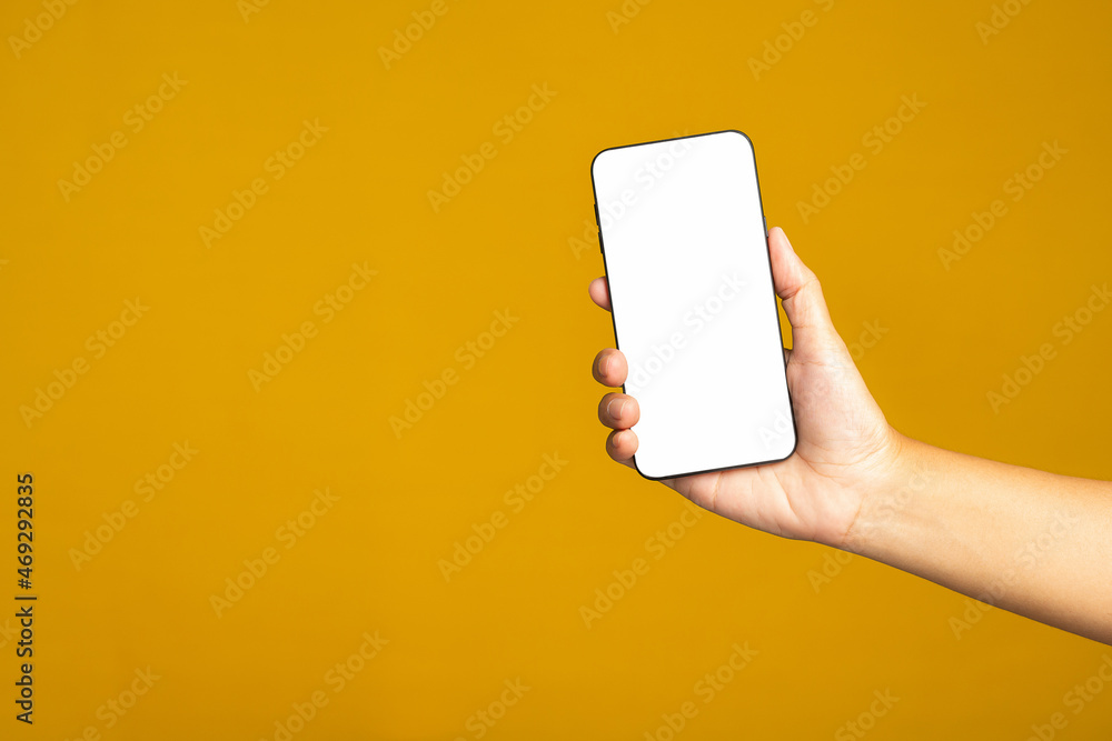 Poster technology and communication concept. hand holding a mobile phone with copy space for text isolated 