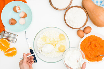 step-by-step recipe for pumpkin curd casserole in the shape of a zebra, orange autumn pie with orange. ingredients for pumpkin pie are visible from the top