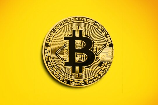 Cryptocurrency Concept With Golden Bitcoin Physical Gold Coin. Symbol Of The Crypto Currency.