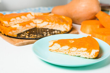 pumpkin casseroles with zebra-shaped cottage cheese, autumn orange pie. cut the pie into pieces on a plate .