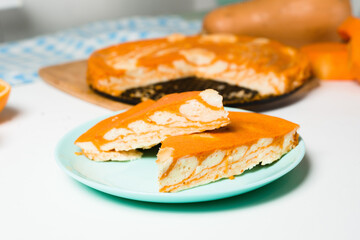 pumpkin casseroles with zebra-shaped cottage cheese, autumn orange pie. cut the pie into pieces on a plate .