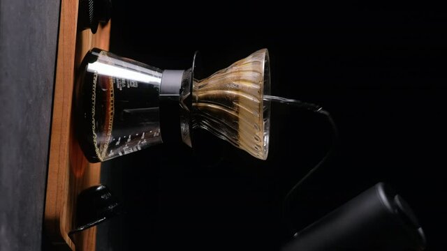 Alternative coffee brewing method, using pour over dripper and paper filter. Vertical video