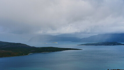 dark rain clouds over fjord in Norway