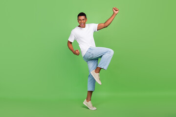 Fototapeta na wymiar Full body profile side photo of young african man celebrate victory fists hands isolated over green color background