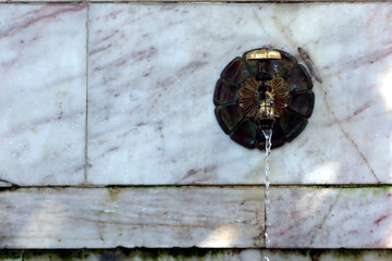 Water source, old faucet sticking out of the wall, for hot summer days. Nesebar, Bulgaria