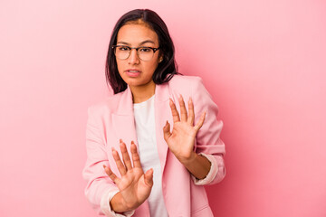 Young latin woman isolated on pink background  rejecting someone showing a gesture of disgust.