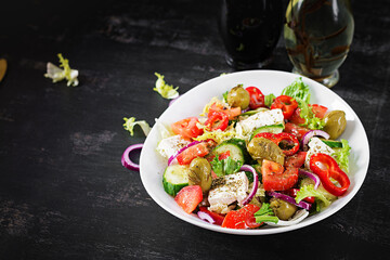 Greek salad of fresh  tomato, sweet pepper, cucumber, red onion, feta cheese and green olives. Healthy vegetarian food.
