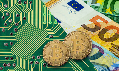 Bitcoin golden coin on green computer circuit board with Euro