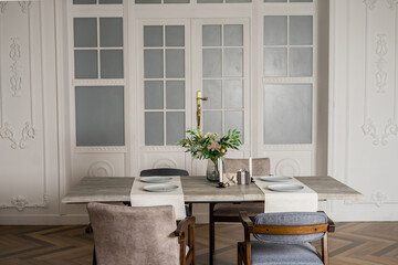 modern dinning room with modern chair and vase of plant on table